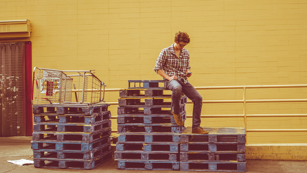 Young man resting on stacks stuffs Stock Photo