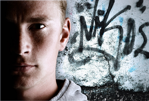 Young man with graffiti on the wall Stock Photo