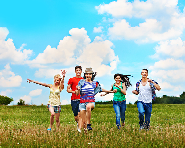 Young men and women running happily Stock Photo