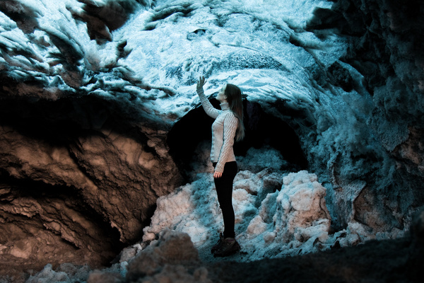 Young woman posing in frozen stone cave Stock Photo