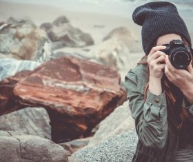 Young woman taking photo with modern camera Stock Photo