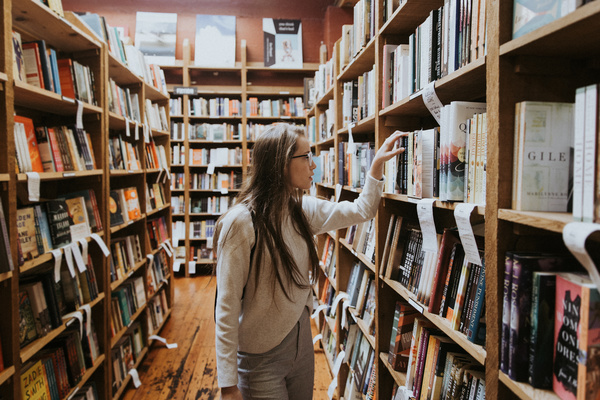 girl looking for books in library Stock Photo