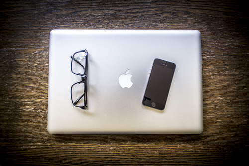 iPhone and Apple laptops on the desktop Stock Photo