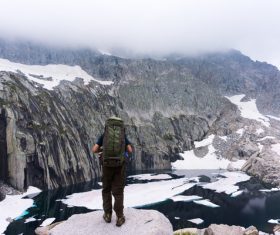 man exploring snowy mountain backpack Stock Photo