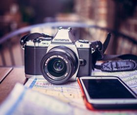 modern camera and smartphone on table Stock Photo