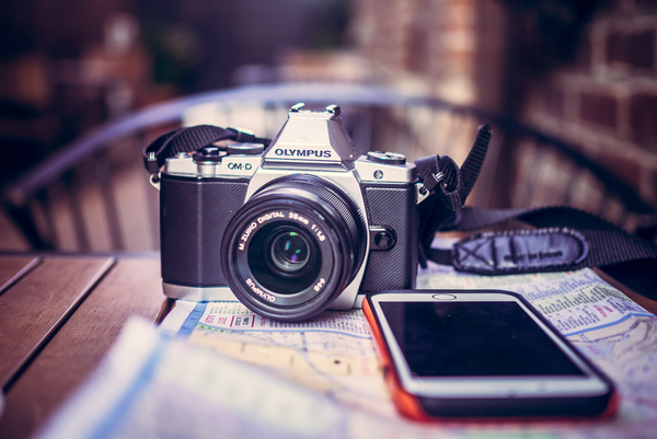modern camera and smartphone on table Stock Photo