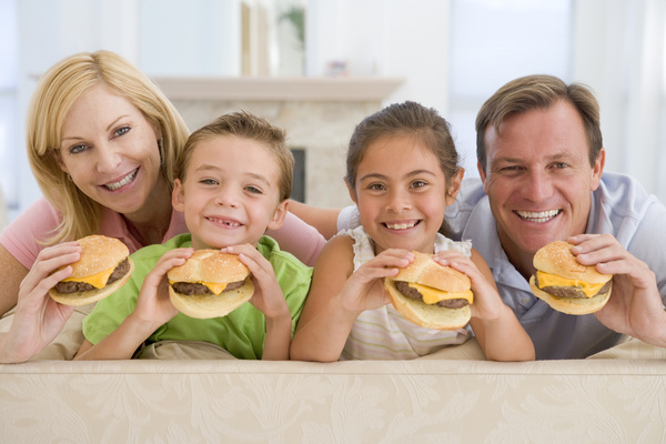 whole family likes to eat hamburgers Stock Photo