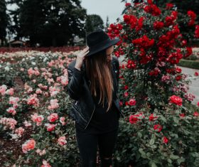 woman posing on beautiful blooming roses garden Stock Photo