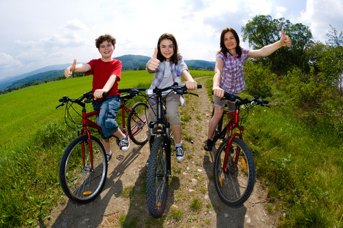 A family of three riding bicycle Stock Photo