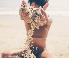 Attractive girl playing with sand Stock Photo