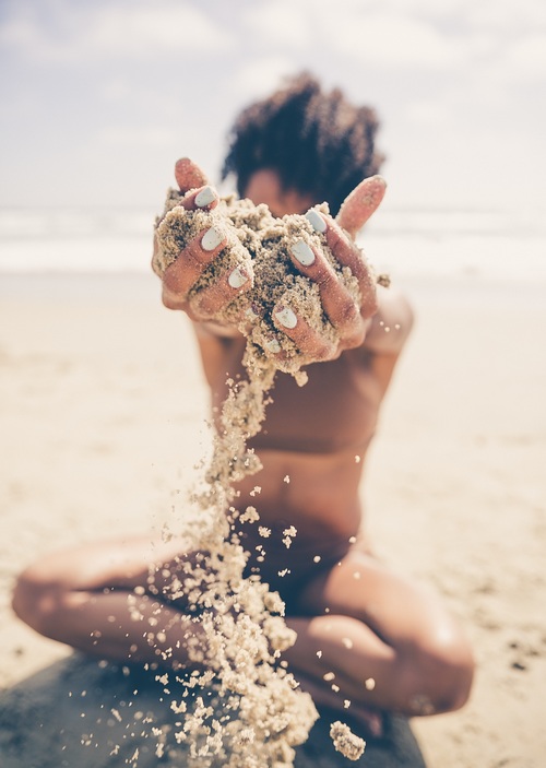 Attractive girl playing with sand Stock Photo