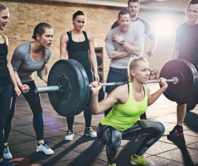 Barbell competition for men and women in the gym Stock Photo