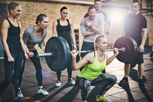 Barbell competition for men and women in the gym Stock Photo