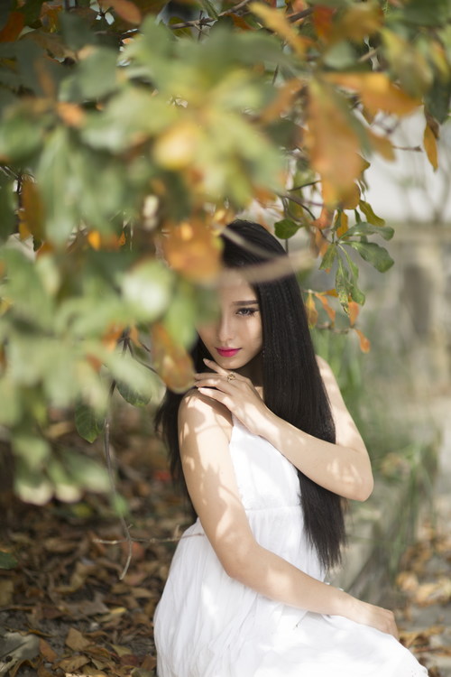 Beautiful asian girl posing under the plant Stock Photo