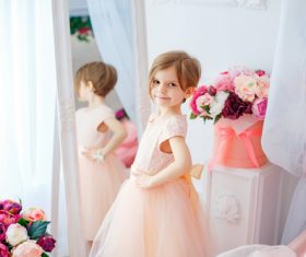 Beautiful little girl dressed in front of the mirror Stock Photo 01