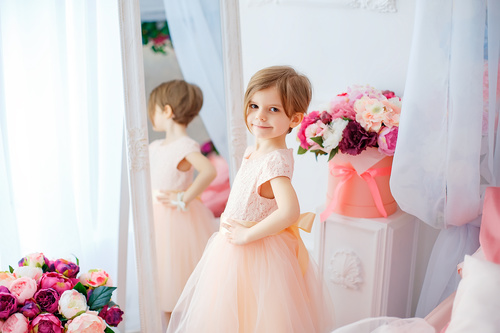 Beautiful little girl dressed in front of the mirror Stock Photo 01