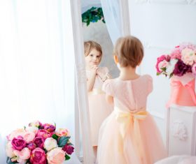 Beautiful little girl dressed in front of the mirror Stock Photo 02