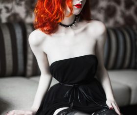 Beautiful redheaded girl wearing black tube top dress Stock Photo
