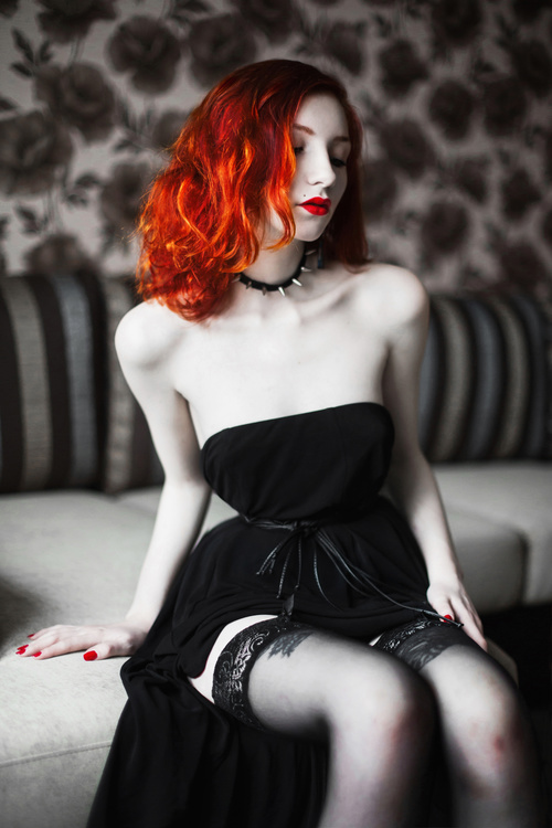 Beautiful redheaded girl wearing black tube top dress Stock Photo