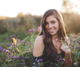 Beautiful woman in flowers field Stock Photo