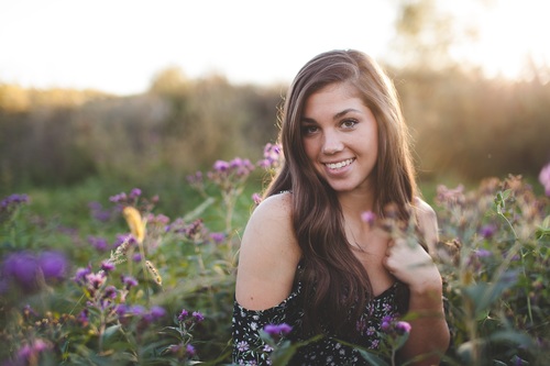 Beautiful woman in flowers field Stock Photo