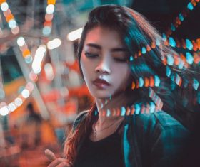 Beautiful young asian girl posing under lights Stock Photo