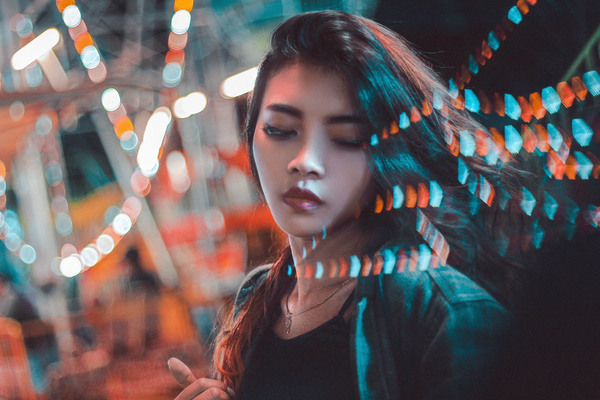 Beautiful young asian girl posing under lights Stock Photo