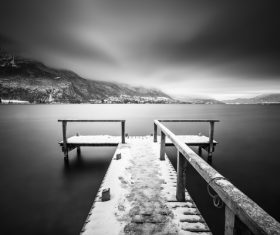 Black white picture of jetty on calm lake Stock Photo