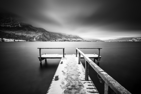Black white picture of jetty on calm lake Stock Photo
