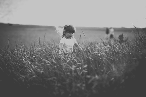 Black white picture of small girl playful outdoor Stock Photo