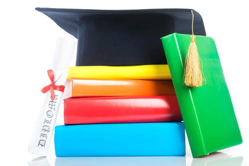 Book diploma and graduation cap Stock Photo