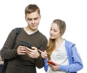 Boy and girl exchanging mobile numbers Stock Photo