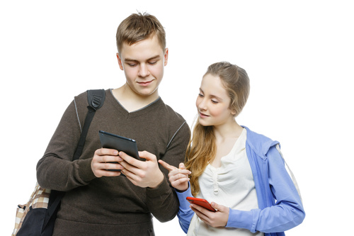 Boy and girl exchanging mobile numbers Stock Photo