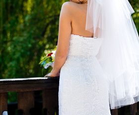 Bride standing on bridge and taking wedding photographs Stock Photo 01