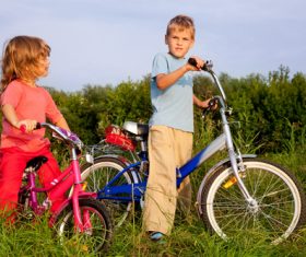 Brother and sister riding bicycle Stock Photo