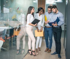 Business people discussing plans in corridor Stock Photo