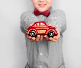 Child holding toy car in hand Stock Photo
