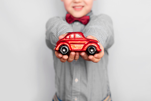 Child holding toy car in hand Stock Photo free download