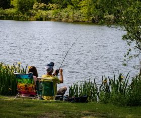 Couple fishing by the river Stock Photo