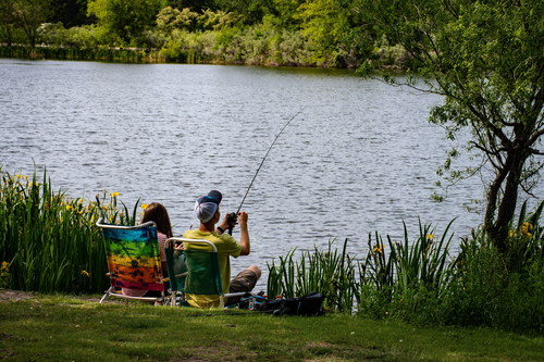 Couple fishing by the river Stock Photo