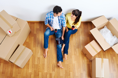 Couple sitting in new home resting Stock Photo