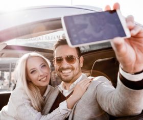 Couple sitting in the car selfie Stock Photo