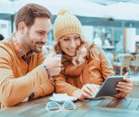 Couple watching videos together at the cafe Stock Photo