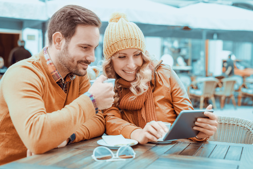 Couple watching videos together at the cafe Stock Photo