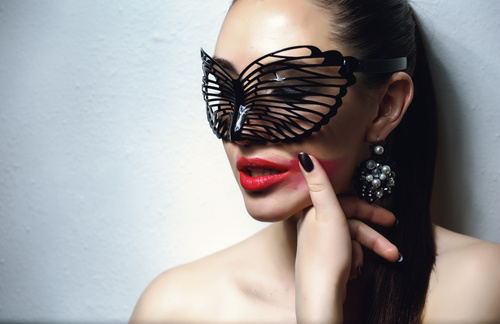 Cute woman wearing black butterfly mask Stock Photo 01