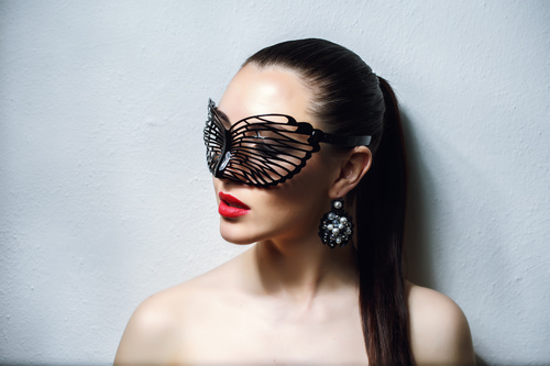 Cute woman wearing black butterfly mask Stock Photo 02