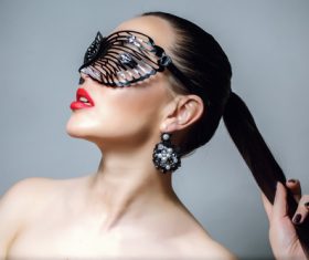 Cute woman wearing black butterfly mask Stock Photo 07