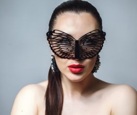 Cute woman wearing black butterfly mask Stock Photo 08