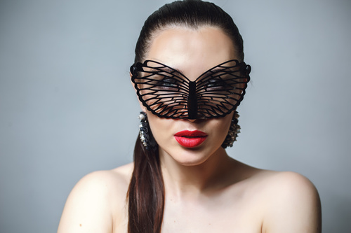 Cute woman wearing black butterfly mask Stock Photo 08