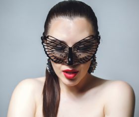Cute woman wearing black butterfly mask Stock Photo 09